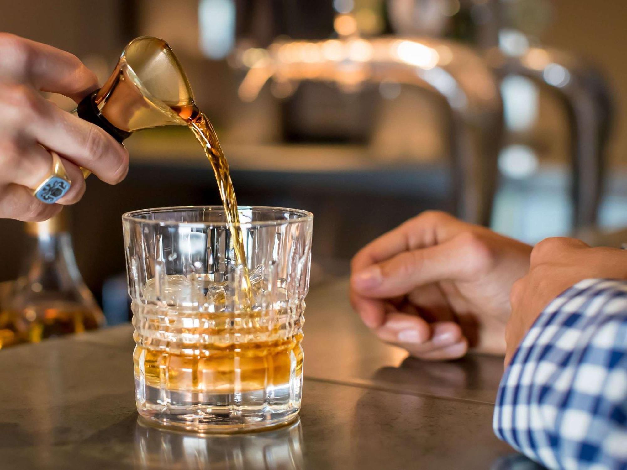 The William Inglis Mgallery Warwick Farm Exterior photo A bartender pouring a glass of Old Fashioned